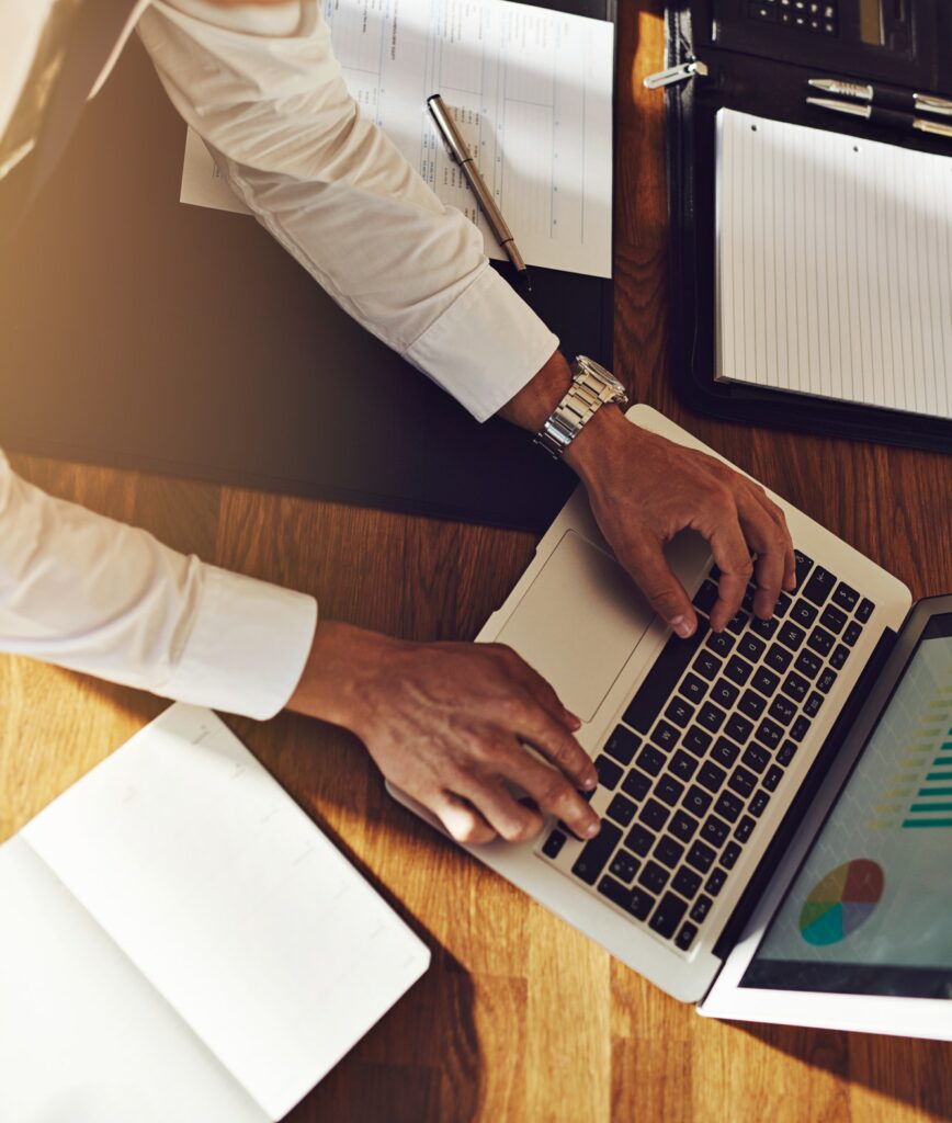 Executive business man working on laptop with graphs