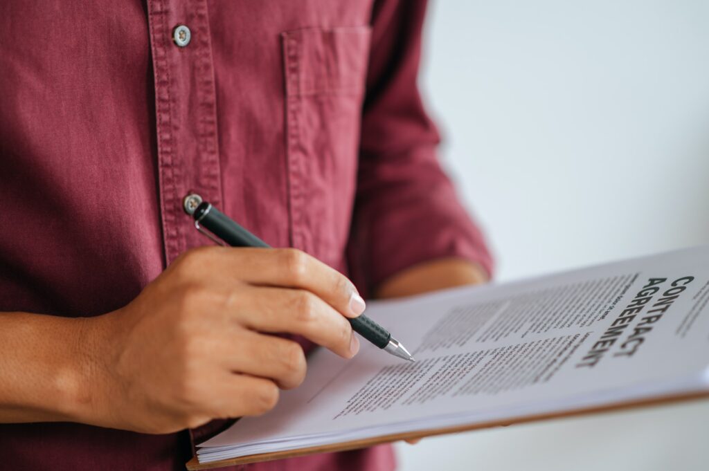 man working in office and holding documents