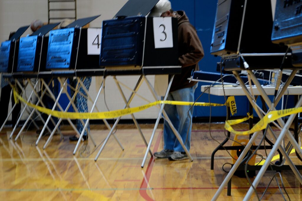 People using voting booths to vote in an election on election day for President elected officials