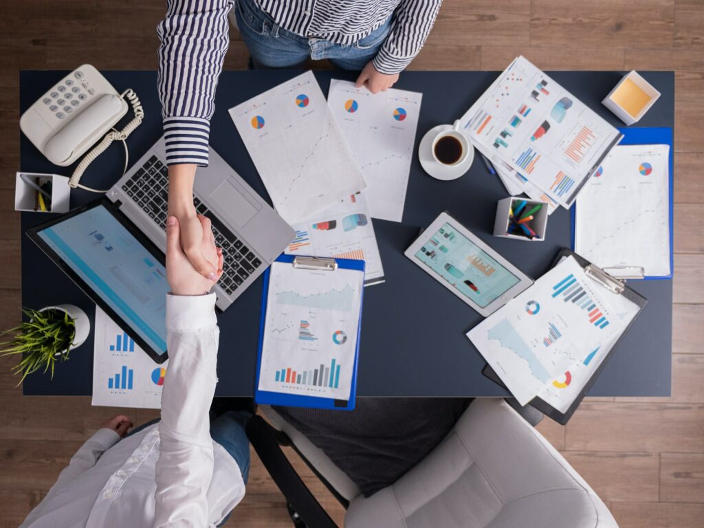 Top view of business women shaking hands in corporate office